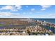 Expansive aerial view of a coastal community with waterfront homes, a marsh, and the ocean under a partly cloudy sky at 310 37Th Ave. N, North Myrtle Beach, SC 29582