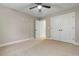 This bedroom features neutral walls, carpet, a ceiling fan, and white closet doors at 3325 Hughes Gasque Rd., Aynor, SC 29511
