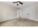 Cozy carpeted bedroom featuring double doors and ceiling fan for added comfort at 3329 Hughes Gasque Rd., Aynor, SC 29511