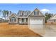 Beautiful gray brick home with a two-car garage and well-manicured lawn at 3329 Hughes Gasque Rd., Aynor, SC 29511
