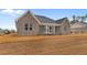 Gray brick house with screened in porch and well-manicured lawn awaiting landscaping at 3329 Hughes Gasque Rd., Aynor, SC 29511
