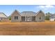 Charming gray brick home featuring a covered porch and classic architectural details at 3329 Hughes Gasque Rd., Aynor, SC 29511