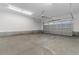 Spacious garage with concrete floor, windowed garage door, and ample lighting at 3329 Hughes Gasque Rd., Aynor, SC 29511