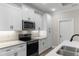 Bright kitchen featuring white cabinets, stainless steel appliances, and quartz countertops at 3329 Hughes Gasque Rd., Aynor, SC 29511
