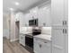 Modern kitchen featuring white cabinets, stainless steel appliances, and quartz countertops at 3329 Hughes Gasque Rd., Aynor, SC 29511