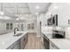 Bright kitchen features white cabinets, stainless steel appliances, and a large island at 3329 Hughes Gasque Rd., Aynor, SC 29511