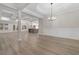 Spacious living room boasting hardwood floors, coffered ceilings, and an open kitchen view at 3329 Hughes Gasque Rd., Aynor, SC 29511