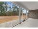 Back patio looking out over the level yard, and scenic tree line at 3329 Hughes Gasque Rd., Aynor, SC 29511