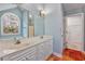 Bathroom featuring a double vanity, an arched window, and tiled floors at 3604 Brampton Dr., Myrtle Beach, SC 29588