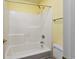Bathroom with a tub and shower combination, featuring white tile and neutral decor at 3604 Brampton Dr., Myrtle Beach, SC 29588
