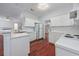Functional kitchen with white cabinetry, hardwood floors, and open layout at 3604 Brampton Dr., Myrtle Beach, SC 29588