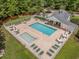 Aerial view of a community pool with lounge chairs, tables, and a fenced-in area for recreation at 3604 Brampton Dr., Myrtle Beach, SC 29588