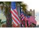 Multiple waving American flags displayed among palm trees in a coastal setting at 405 21St Ave. S # 2H, North Myrtle Beach, SC 29582