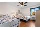 Comfortable bedroom featuring two beds, nautical-themed bedding, and a ceiling fan at 405 21St Ave. S # 2H, North Myrtle Beach, SC 29582