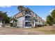 Exterior view of a multi-story condo building with a private balcony surrounded by lush palm trees at 405 21St Ave. S # 2H, North Myrtle Beach, SC 29582