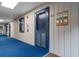 A hallway with a blue door featuring a sign saying Leave Your Sandy Shoes At The Door at 405 21St Ave. S # 2H, North Myrtle Beach, SC 29582