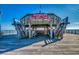 Sturdy wooden fishing pier featuring an elevated center platform with benches and dual staircases at 405 21St Ave. S # 2H, North Myrtle Beach, SC 29582