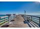 Scenic wooden fishing pier with benches and distant views of the ocean on a sunny day at 405 21St Ave. S # 2H, North Myrtle Beach, SC 29582