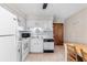 Functional kitchen with white cabinets, appliances, stainless steel sink, and adjacent breakfast table seating at 405 21St Ave. S # 2H, North Myrtle Beach, SC 29582