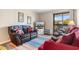 Cozy living room featuring a sleeper sofa with nautical pillows, a tv, and a sliding door to the outdoor space at 405 21St Ave. S # 2H, North Myrtle Beach, SC 29582