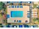 Aerial view of a community pool with lounge chairs, tables, and lush landscaping at 405 21St Ave. S # 2H, North Myrtle Beach, SC 29582