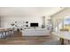 Bright living room featuring modern furniture, an adjacent kitchen, and sliding glass doors at 423 Clear Lake Dr., Conway, SC 29526