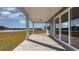 Inviting covered patio with sliding glass doors, overlooking a serene lake and lush green space at 423 Clear Lake Dr., Conway, SC 29526