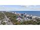 Stunning aerial view showcasing a beachfront community near the ocean and city skyline at 5368 Ocean Village Dr., Myrtle Beach, SC 29577