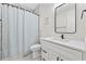 Bright bathroom with white vanity, marble countertop, shower with curtain, and contemporary finishes at 5368 Ocean Village Dr., Myrtle Beach, SC 29577