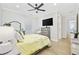 Inviting bedroom featuring large TV, hardwood floors, and comfortable bedding for a relaxing retreat at 5368 Ocean Village Dr., Myrtle Beach, SC 29577
