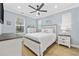 Comfortable bedroom with light blue walls, white furniture, and hardwood floors for a relaxing retreat at 5368 Ocean Village Dr., Myrtle Beach, SC 29577