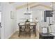 Dining area featuring hardwood floors, exposed beams, and view of staircase to the second floor at 5368 Ocean Village Dr., Myrtle Beach, SC 29577