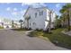 Attractive exterior with a well-manicured lawn and tropical palm trees at 5368 Ocean Village Dr., Myrtle Beach, SC 29577