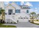 Beautiful two-story home featuring a white exterior, well-manicured landscaping, and a welcoming front porch at 5368 Ocean Village Dr., Myrtle Beach, SC 29577