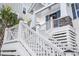 Close up of front entrance showing porch with decorative wreath, stone accents, and stairway at 5368 Ocean Village Dr., Myrtle Beach, SC 29577