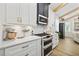 Well-lit kitchen with stainless steel appliances, white cabinetry, and marble countertops at 5368 Ocean Village Dr., Myrtle Beach, SC 29577