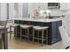 Kitchen island with white marble countertop, seating, and stainless steel appliances at 5368 Ocean Village Dr., Myrtle Beach, SC 29577