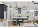 Modern kitchen with white cabinets, quartz countertops, black island, and stainless steel appliances at 5368 Ocean Village Dr., Myrtle Beach, SC 29577