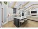 Open eat-in kitchen featuring black and white cabinets, island with seating, and stainless steel appliances at 5368 Ocean Village Dr., Myrtle Beach, SC 29577
