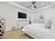 Bright primary bedroom with wood floors, white furniture and decor, and a tray ceiling at 5368 Ocean Village Dr., Myrtle Beach, SC 29577