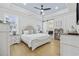 Light, spacious primary bedroom featuring a tray ceiling and a decorative ceiling fan at 5368 Ocean Village Dr., Myrtle Beach, SC 29577