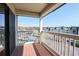 View of the parking area from the balcony, with wooden floors and white railing at 5601 N Ocean Blvd. # B306, Myrtle Beach, SC 29577