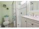 Modern bathroom featuring a glass shower, marble countertop, and refreshing green walls at 5601 N Ocean Blvd. # B306, Myrtle Beach, SC 29577