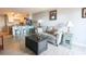 A spacious living room featuring a comfortable sofa, stylish decor, and a view of the kitchen at 5601 N Ocean Blvd. # B306, Myrtle Beach, SC 29577