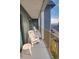 Outdoor balcony with white chairs overlooking the parking lot and ocean view at 5905 S Kings Highway # 432-A, Myrtle Beach, SC 29575