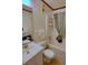 Neutral-toned bathroom with shower-tub, white fixtures and sink, towel racks, and colorful striped shower curtain at 5905 S Kings Highway # 432-A, Myrtle Beach, SC 29575