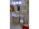 Well-lit bathroom offers a mirror, white sink vanity, toilet, and shower at 5905 S Kings Highway # 432-A, Myrtle Beach, SC 29575