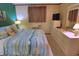 Bright bedroom features a bed with sea-themed comforter, dresser, and light neutral colored walls at 5905 S Kings Highway # 432-A, Myrtle Beach, SC 29575