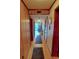 Inviting hallway leading to a sunlit living area and featuring wood paneling at 5905 S Kings Highway # 432-A, Myrtle Beach, SC 29575