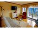 Inviting living room with a striped sofa, a comfortable chair, and a balcony with a view at 5905 S Kings Highway # 432-A, Myrtle Beach, SC 29575